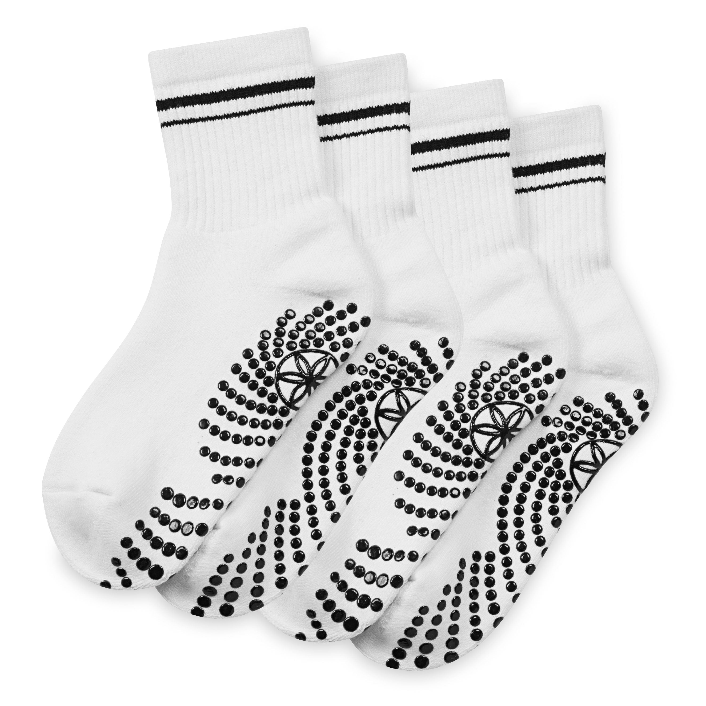 Set of white socks with black stripes and textured sole on a white background